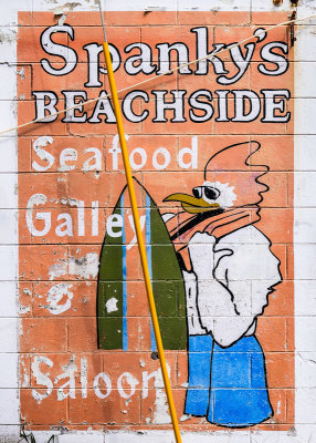 Restaurant advertisement on the side of a Tybee Island building along Coastal Georgia