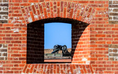 Cannon as seen through a port in the fort wall in Fort Pulaski National Monument