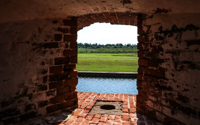 View outside the fort through a cannon port in Fort Pulaski National Monument