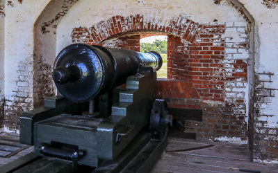 Large cannon positioned in a wall port in Fort Pulaski National Monument