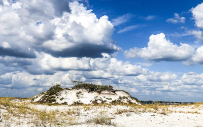 Clouds over a white sand dune on Santa Rosa Island in Gulf Islands National Seashore