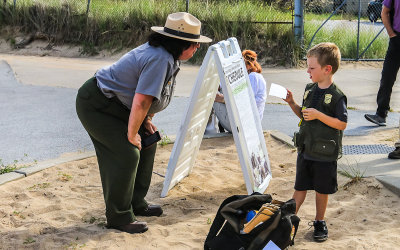 Park Ranger and Junior Ranger discuss the virtues of Indiana Dunes National Park