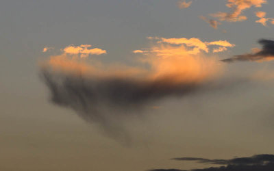 Small cloud morphing at sunset
