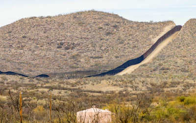 The border wall cuts through a hill in the Arizona Border Zone