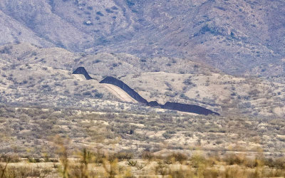 The border wall snakes over the desert in the Arizona Border Zone