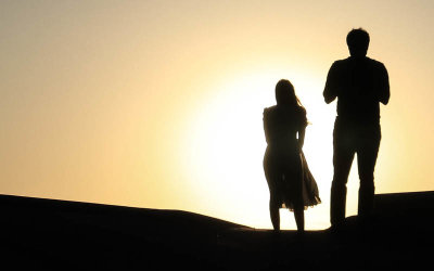 The setting sun frames a couple at Zabriskie Point in Death Valley National Park