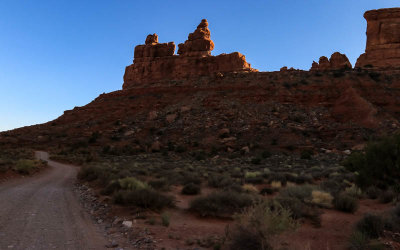 The sun behind the Rudolph and Santa Claus formation in Valley of the Gods