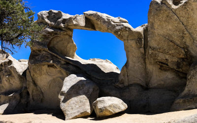 Window Arch frames a clear deep blue sky in City of Rocks National Reserve