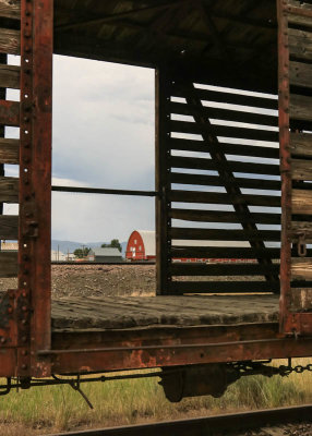 View of the Warren Barn through a cattle rail car in Grant-Kohrs Ranch NHS