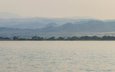 Smoke covered mountains in the distance beyond Ennis Lake