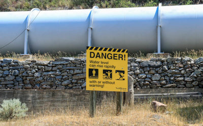 Dam sign near the Madison hydroelectric dam in Bear Trap Canyon