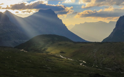 The sun’s rays fall on a field at Logan Pass in Glacier National Park