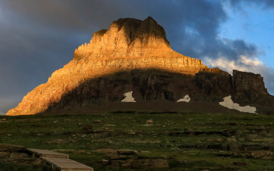 An arc of bright sunlight on Clements Mountain at Logan Pass in Glacier National Park