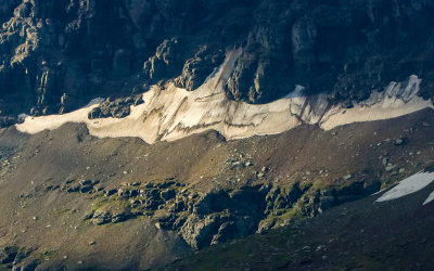 Snow tucked into a crevasse at the base of Clements Mountain at Logan Pass in Glacier National Park