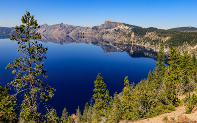 Llao Rock (8,049 ft) reflected in Llao Bay in Crater Lake in Crater Lake National Park