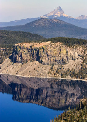 The Crater Lake rim reflected in the lake with Mt. Thielsen (9,182 ft) in the distance in Crater Lake National Park