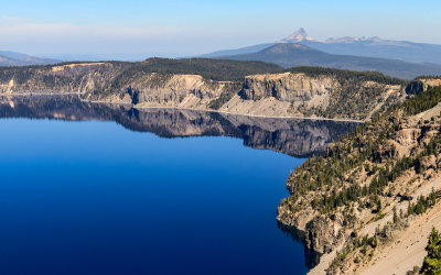 Crater Lake rim mirrored in the lake with Mt. Thielsen in the distance in Crater Lake National Park