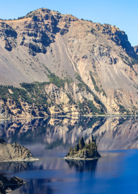 The Crater Lake rim looms over the Phantom Ship Island in Crater Lake National Park