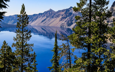 The Crater Lake rim reflected in the blue waters in Crater Lake National Park