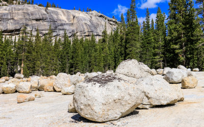 Glacial erratic boulders sit below a granite dome along the Tioga Road in Yosemite National Park