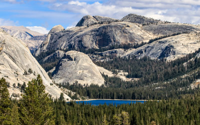 Tenaya lake lies in the foreground before Polly Dome (left), Pywiack Dome and Medlicott Dome  in Yosemite National Park