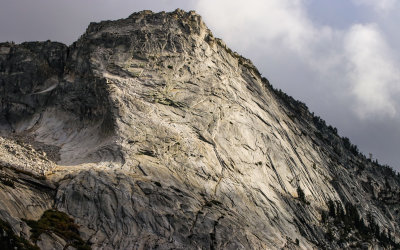 Sunlight paints the granite face of Cloud Rest (9,926 ft) as viewed from Olmsted Point in Yosemite National Park