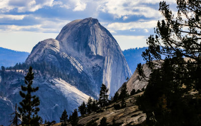 Late day sunlight strikes the face of Half Dome in the Yosemite Valley as seen from Olmsted Point in Yosemite National Park
