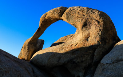 Mobius Arch against a deep blue early morning sky in the Alabama Hills National Scenic Area