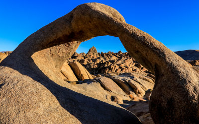 Rock formations in early morning light as seen through Mobius Arch in the Alabama Hills National Scenic Area