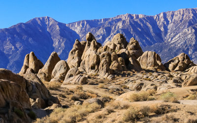 The Sierra Nevada Range looms over a rock formation in the Alabama Hills National Scenic Area