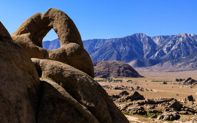 The Eye of Alabama Hills Arch overlooks the Sierra Mountain Range in the Alabama Hills National Scenic Area