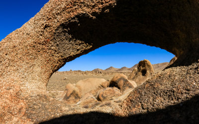 View of rock formations through One Mile Arch in the Alabama Hills National Scenic Area