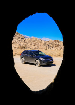 Subaru viewed through the Hidden Window Arch in the Alabama Hills National Scenic Area