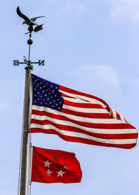 US and five-star flags flying in back of the home in Eisenhower NHS