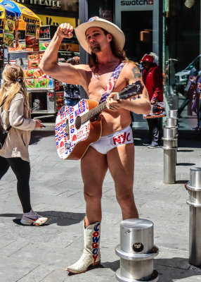 The Naked Cowboy playing guitar in Times Square