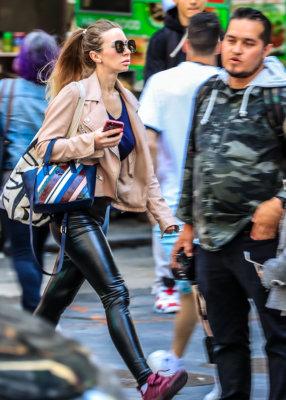 Times Square Fan walks briskly through Times Square