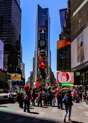 Digital Billboards and costumed characters surround One Times Square building in Times Square