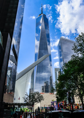 One World Trade Center stands tall over lower Manhattan and the 9/11 Memorial Grounds