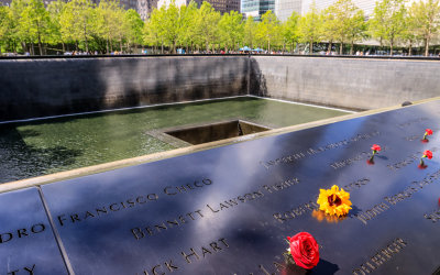 Flowers placed on the memorial at the South Pool on the 9/11 Memorial Grounds