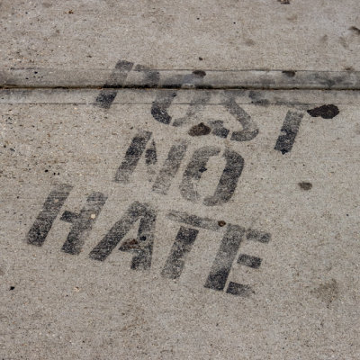POST NO HATE stenciled on the sidewalk at the Stonewall Inn in Stonewall NM
