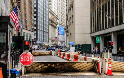 Barricades on Wall Street with the New York Stock Exchange (NYSE) in the distance in New York City