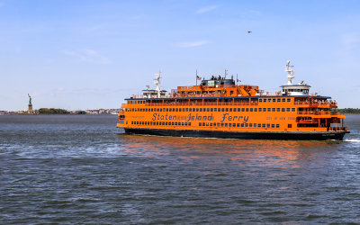 Staten Island Ferry heads past the Statue of Liberty in New York City