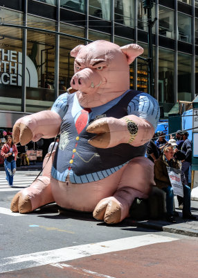 Protester makes a statement about greedy corporations on a street in New York City