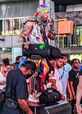 Dancer armed with a boom box and weed in Times Square at Night