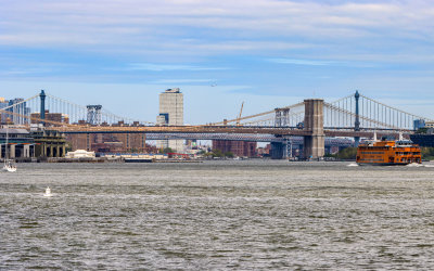 The Staten Island Ferry and the Brooklyn, Manhattan and Williamsburg Bridges over the East River