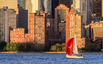 Sailboat before sunset at the foot of the NYC Skyline on the Hudson River 