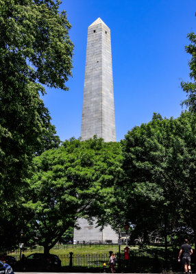 The Bunker Hill Monument through the trees in Boston NHP