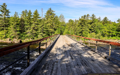 One-lane wooden-decked bridge over the Penobscot River in Katahdin Woods and Waters NM