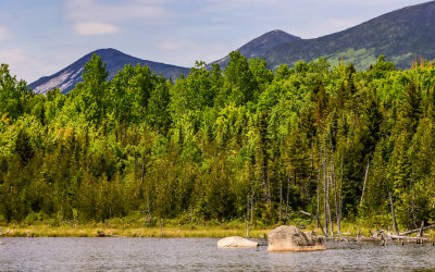 Peaks seen over boulders in a pond in Baxter State Park