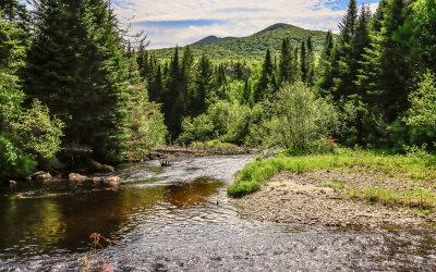 Hills and mountains viewed over a river in Baxter State Park